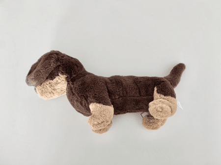 <b>Plush Dog from Above3</b><br>In this photo, I captured a top view of a cute plush dog with a mix of brown and tan fur using my phone. The soft textures and playful design make it visually appealing, while the neutral background helps the colors pop. The angle provides a clear view of the dog's features, emphasizing its adorable shape.