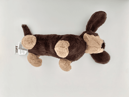 <b>Plush Dog from a Different Angle</b><br>In this shot, I took a different angle of the same plush dog with my phone, showcasing its friendly expression and soft ears. The varied lighting highlights the fur's texture, giving it a cozy and inviting look. This perspective adds depth to the image, allowing the viewer to appreciate the craftsmanship of the plush toy.