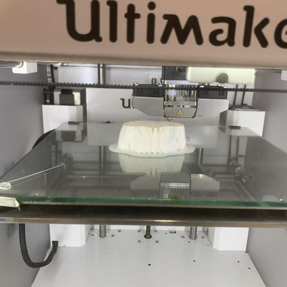 <b>3D Printing Process</b><br>Here is my model being 3D printed on an Ultimaker printer. The printer is carefully laying down layers of material to build the shape I designed. 
