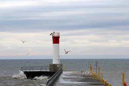 <b>Lighthouse at Oakville Lakeshore</b><br>I downloaded this image from Pexels, and it shows the lighthouse at the Oakville lakeshore. Originally, lighthouses like this one were used to guide ships safely to the shore, especially during storms or low visibility. Today, while it may still serve as a navigational aid, it has also become a scenic spot for visitors and photographers to enjoy the natural beauty of the lake.