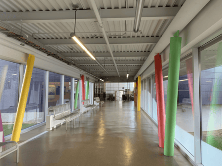 <b>Colorful Hallway with Foam Pillars</b><br>This photo shows a hallway at Sheridan campus, which I took with my phone. Initially designed as a simple passageway, it now features colorful foam pillars that add a playful touch to the space, making it more visually engaging for students.