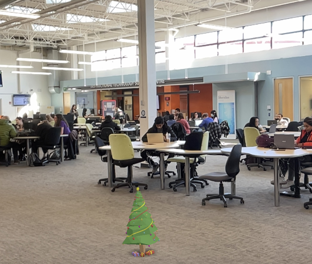 
<b>AR Christmas Tree in Learning Common </b><br>
I included this image to show a fun, seasonal decoration in the study area through AR. It represents a virtual Christmas tree placed in the space to bring a festive and cheerful vibe for the holiday season. My main takeaway is that AR can quickly transform the environment's mood and add a sense of celebration, making shared spaces more dynamic and engaging.
