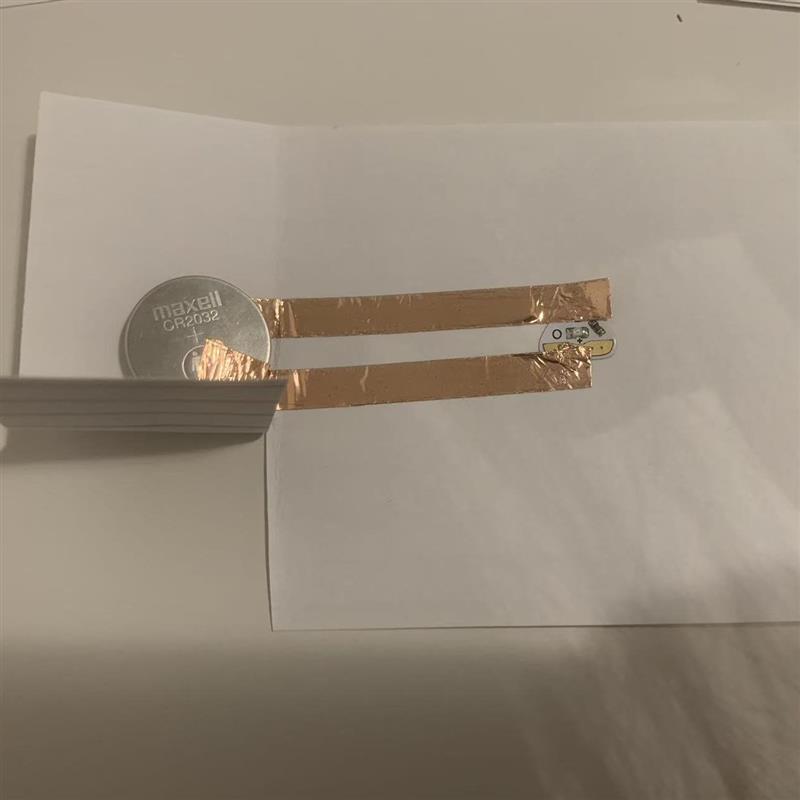 I carefully placed copper tape to create the circuit connections. The setup ensures a secure path for electricity to flow.