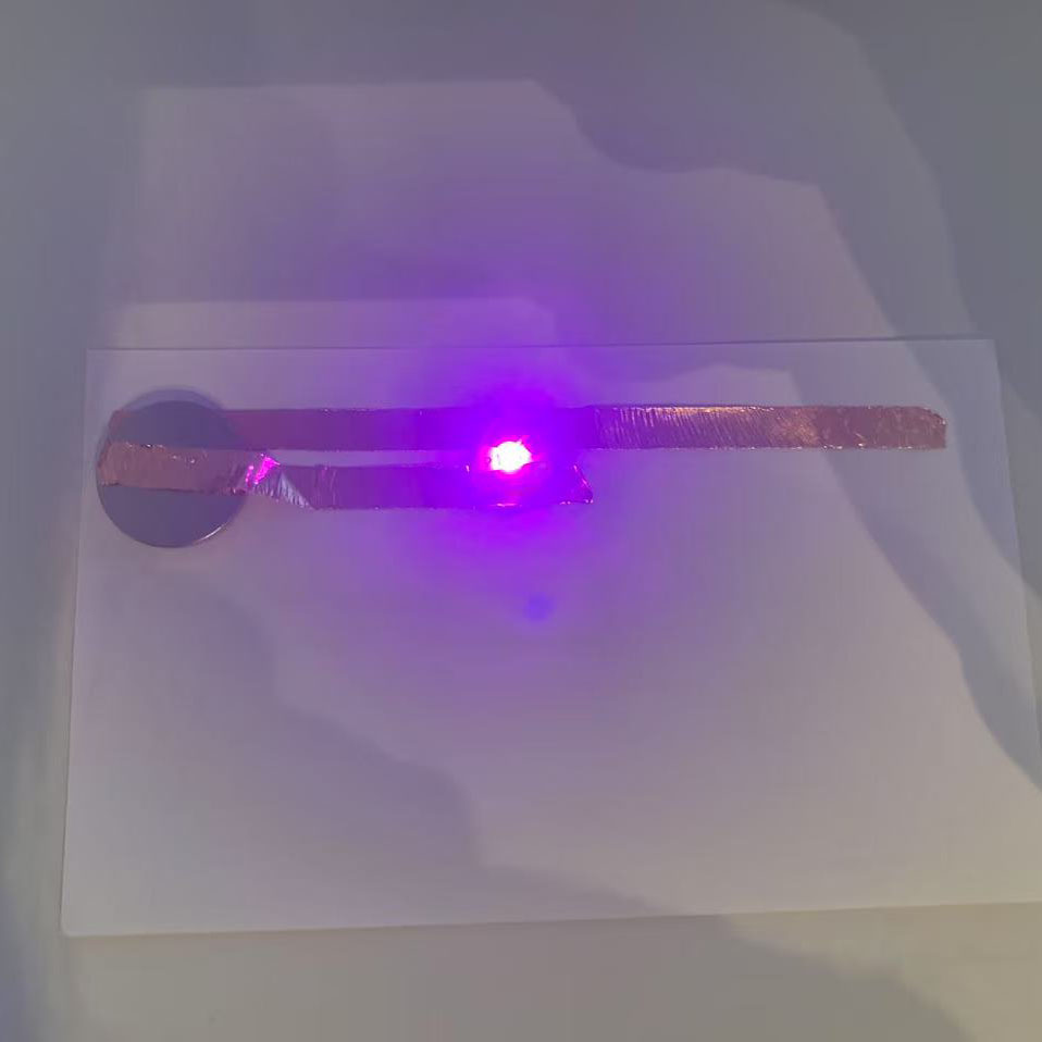 I followed tutorial1 to build this circuit using copper tape, a battery, and an LED. The purple light shows that my circuit works successfully.