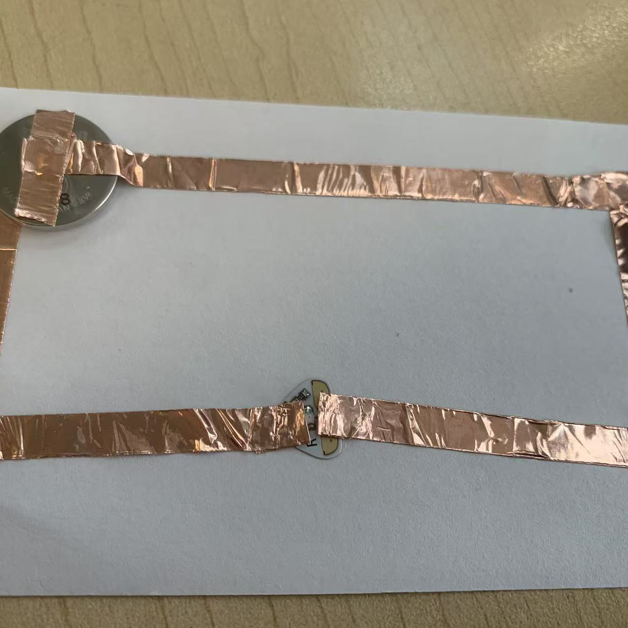 I used copper tape, a coin battery, and an LED to assemble this rectangular circuit. It matches my original diagram.