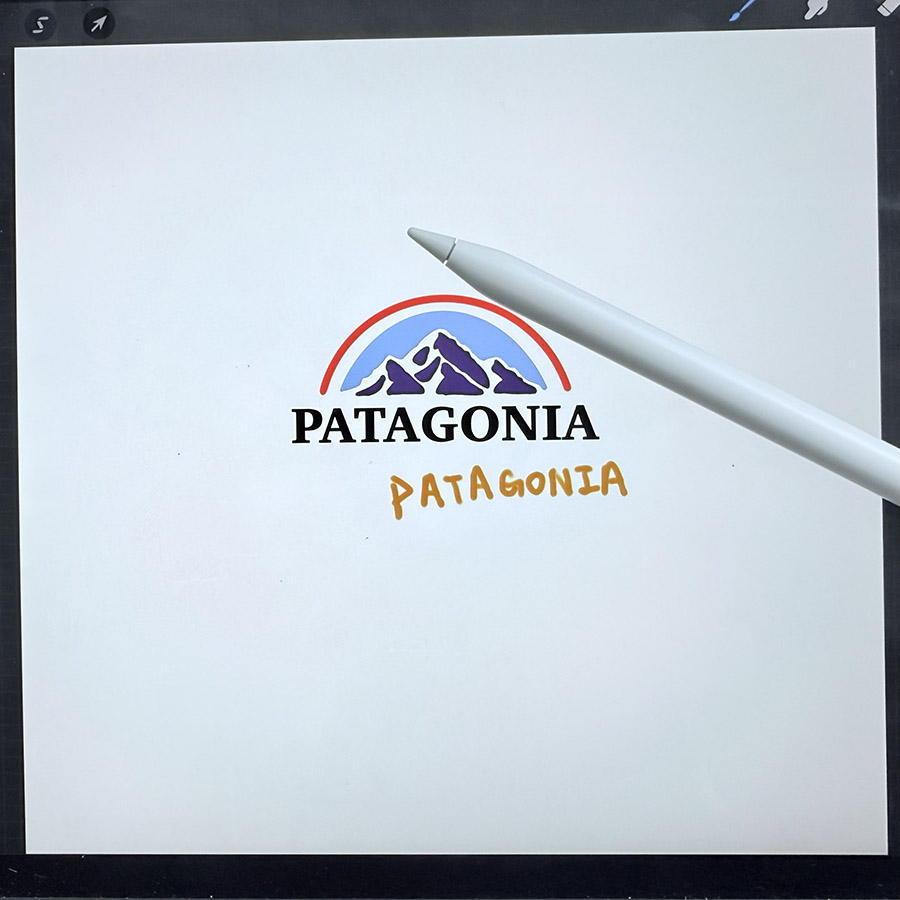An Apple Pencil rests on a digital drawing pad displaying the Patagonia logo, capturing the subtle sound of writing or drawing.