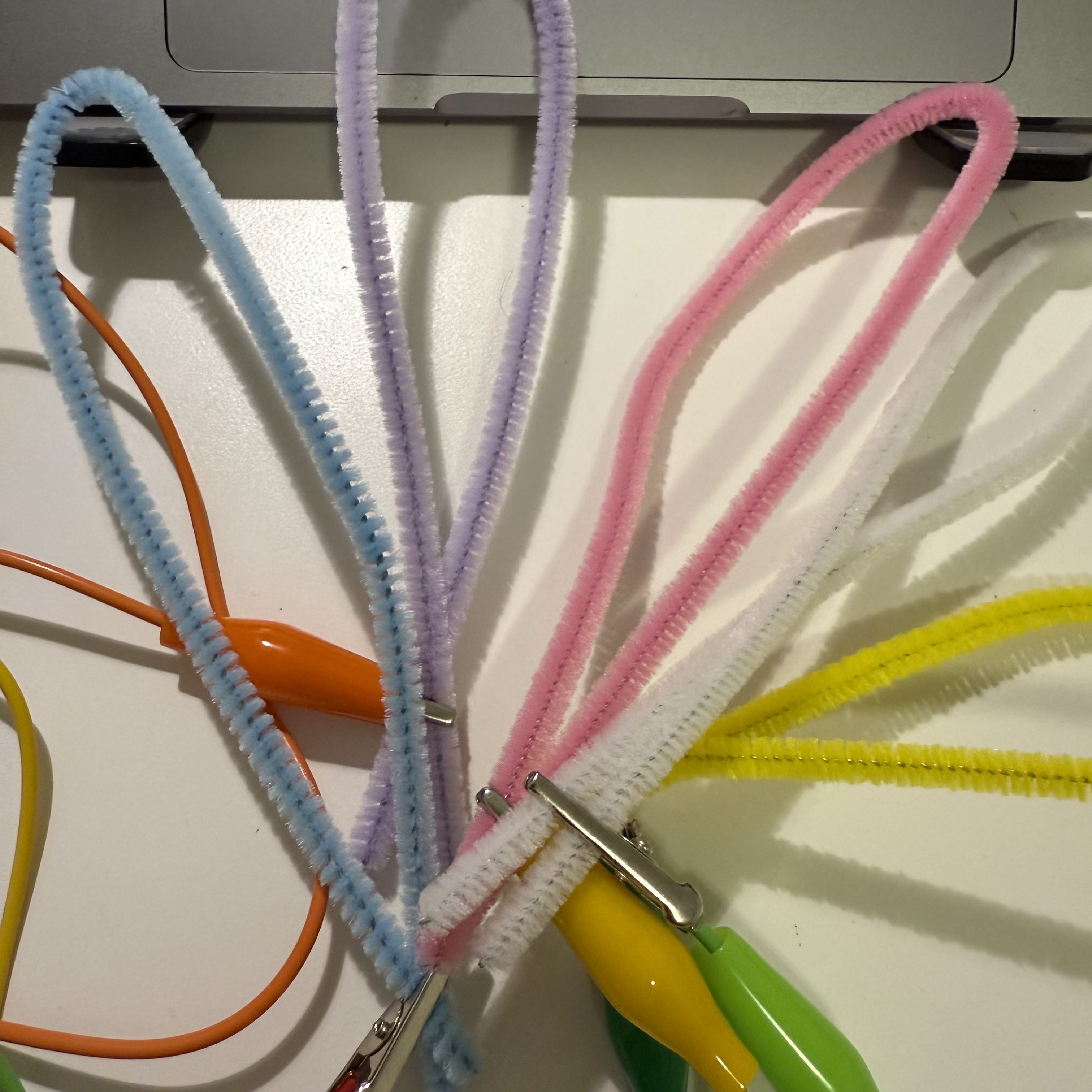 In my project, I use colorful pipe cleaners connected to a Makey Makey board via alligator clips. These serve as playful, tactile elements that control different commands on my computer. Each touch on these pipe cleaners translates into an input signal, which is fun and interactive.