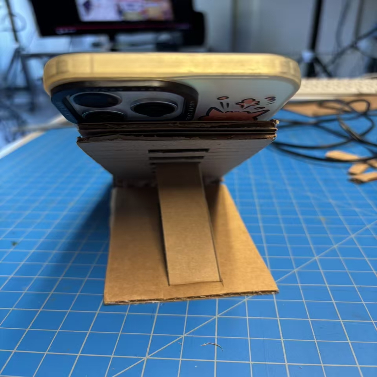 <b>Final Model</b>We complete the stand and test it by placing a phone on top, and the cardboard structure is strong enough to hold the device securely while offering a comfortable viewing angle.
