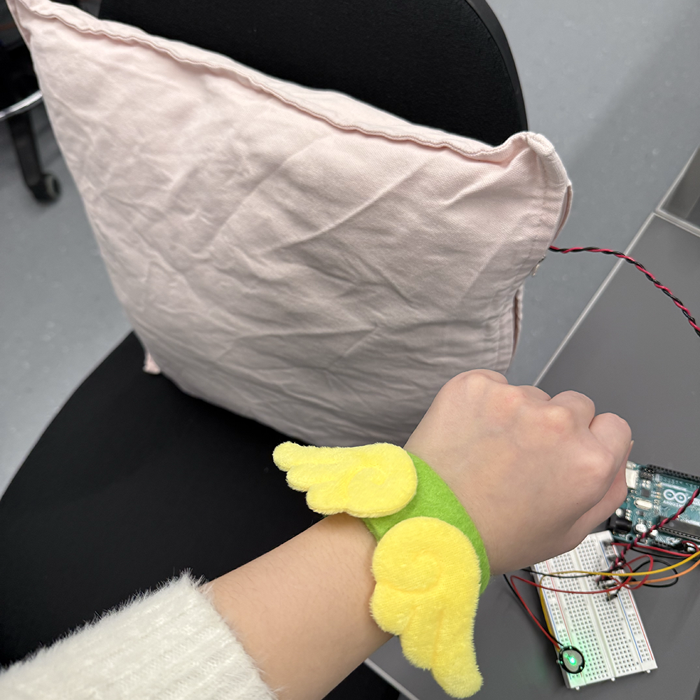 <b>Testing Wearing and Interaction</b><br>We tested how the wrist band fits on the user and how the cushion responds when someone leans on it. This helped us check the positions of the pulse sensor and the force sensor, making sure the user can interact with the prototype in a natural way.